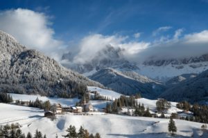 Village and church in the Dolomites in winter